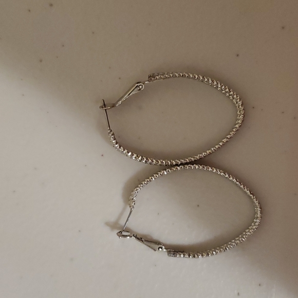 not sure Jewelry - Silver oval hoop earrings with clasp closure back.  Faux Silver.